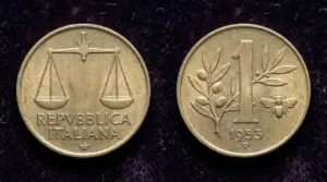 Moneta da 1 lira con ape del 1953, fronte e retro, fotografata su sfondo scuro